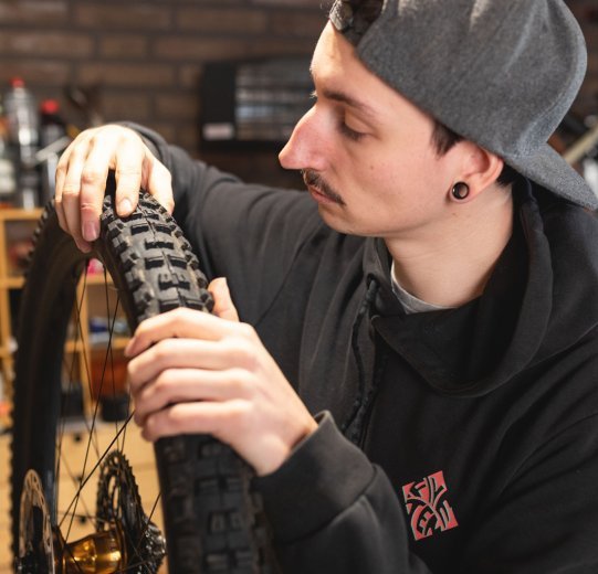 bc Mechanic Pascal checks a tyre for cracks and damage. 