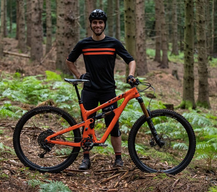 Christian from bc Product Management presents his orange YETI MTB. He wears a bc original jersey to match.