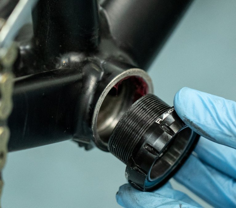 The drive side of a bottom bracket is screwed in by hand.