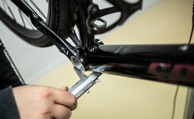 A caliper gauge is used on a Specialized bike to determine the width of the bottom bracket shell.